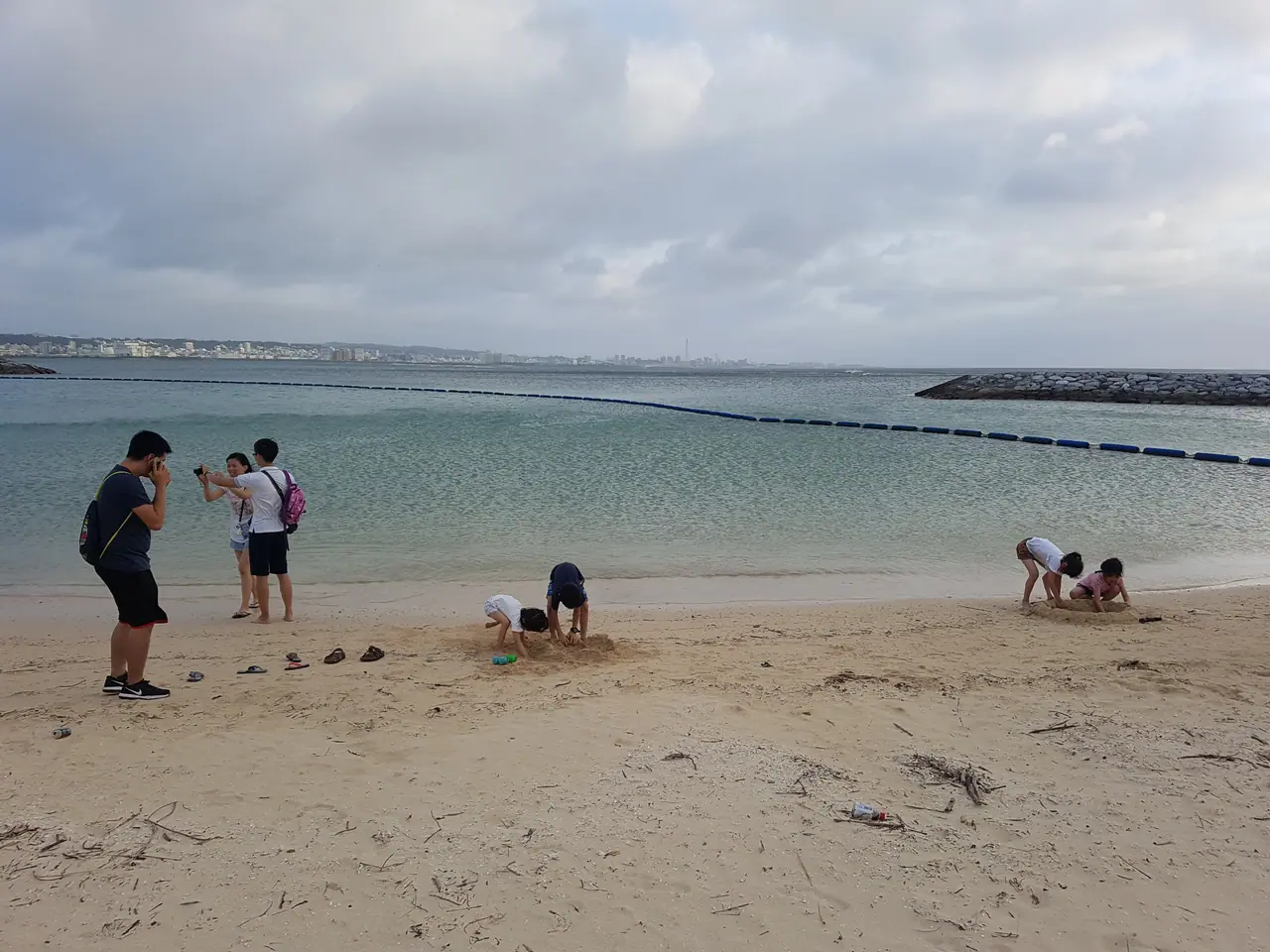 Children playing in the sand at a beach in Okinawa
