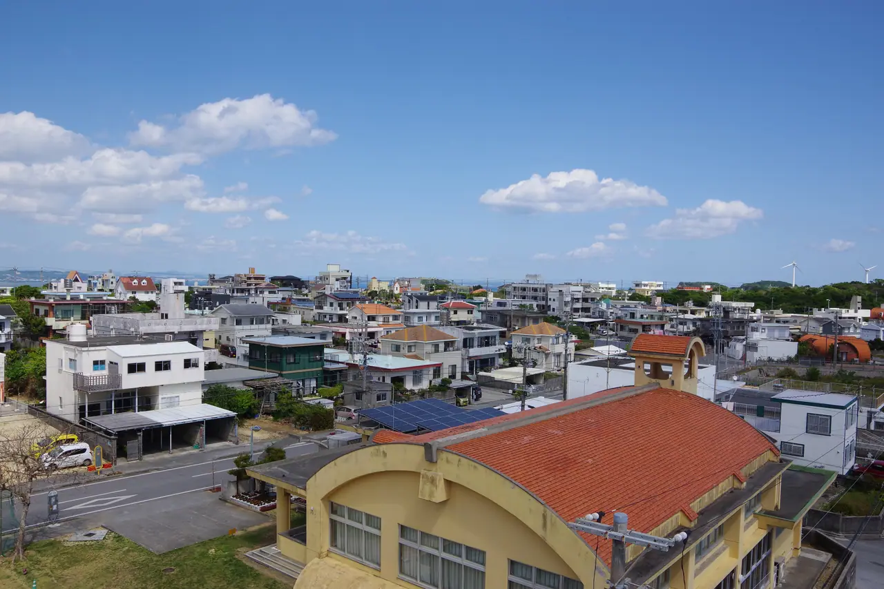Rooftops of a residential neighbourhood in Nanjo, with the sea beyond